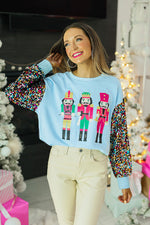 Nutcrackers on Blue Sweatshirt with Sequin Sleeves